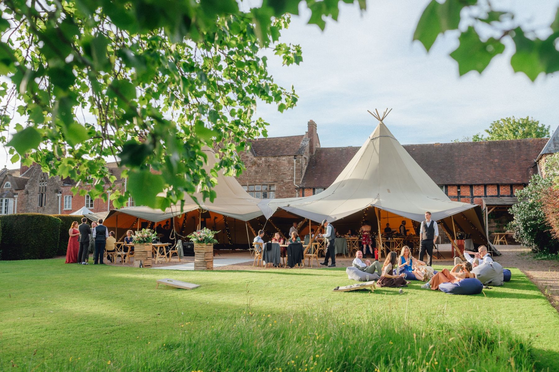 Ali and Emma's guests on the manor lawn by the tipis